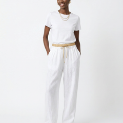 Women’s tapered linen trousers by Christine Brewer featuring loose fit, pull-on design, and lightweight breathable fabric.
