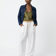 Loose tapered linen trousers for women by Christine Brewer, featuring a relaxed fit and pull-on style in natural linen fabric.