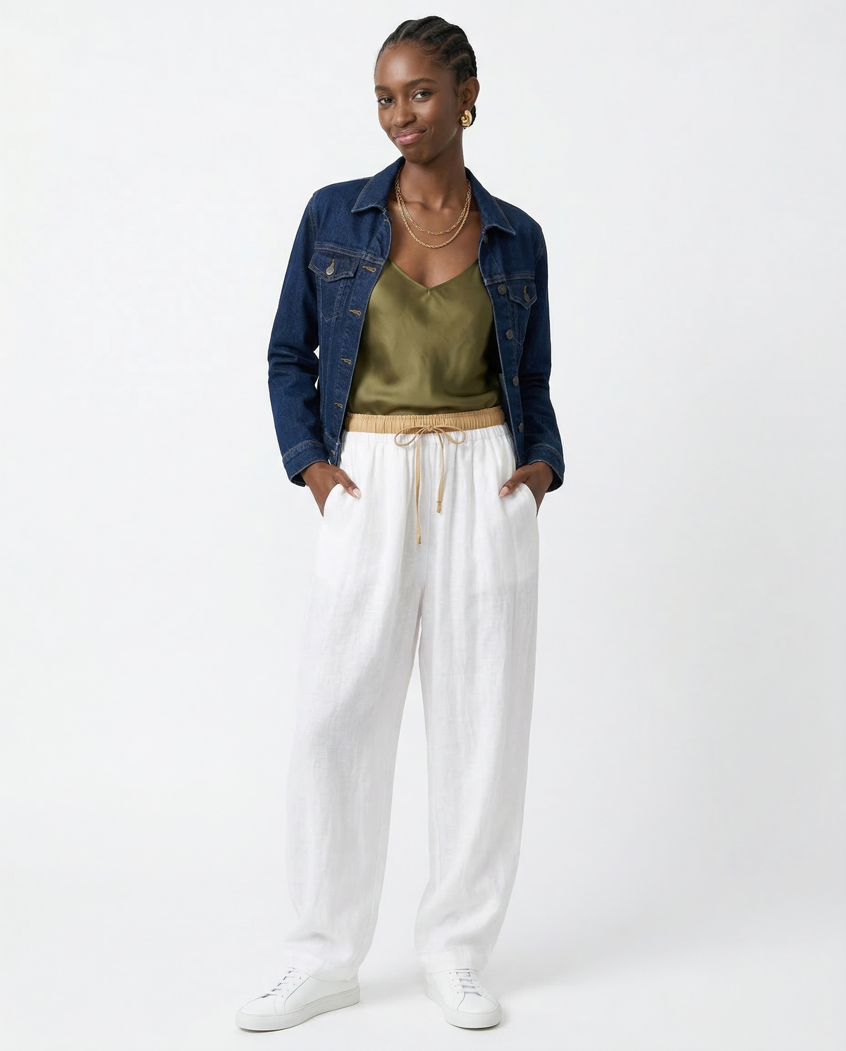 Loose tapered linen trousers for women by Christine Brewer, featuring a relaxed fit and pull-on style in natural linen fabric.