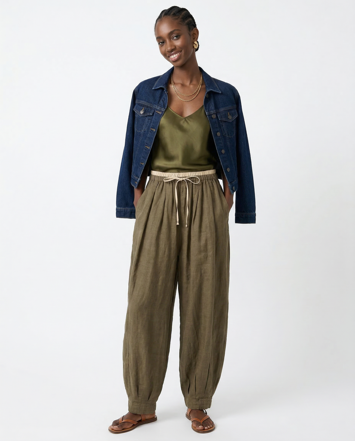 Women’s tapered linen trousers by Christine Brewer featuring a loose fit and pull-on design, shown in a neutral color.