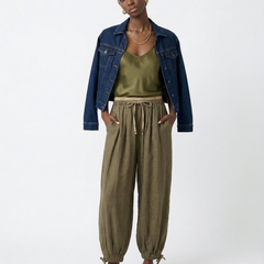 Women’s tapered linen trousers by Christine Brewer, loose pull-on pants with a relaxed fit and natural linen fabric.