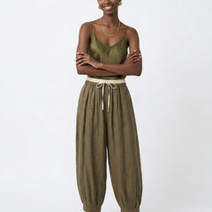Women’s tapered linen trousers by Christine Brewer, loose pull-on style, lightweight natural fabric, casual and comfortable pants.