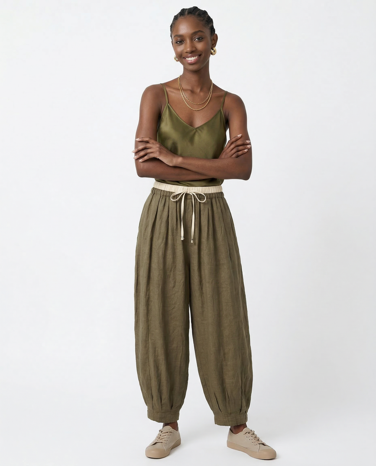 Women’s tapered linen trousers by Christine Brewer, loose pull-on style, lightweight natural fabric, casual and comfortable pants.