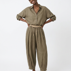 Loose tapered linen trousers for women by Christine Brewer, featuring a relaxed fit and pull-on style in natural linen fabric.