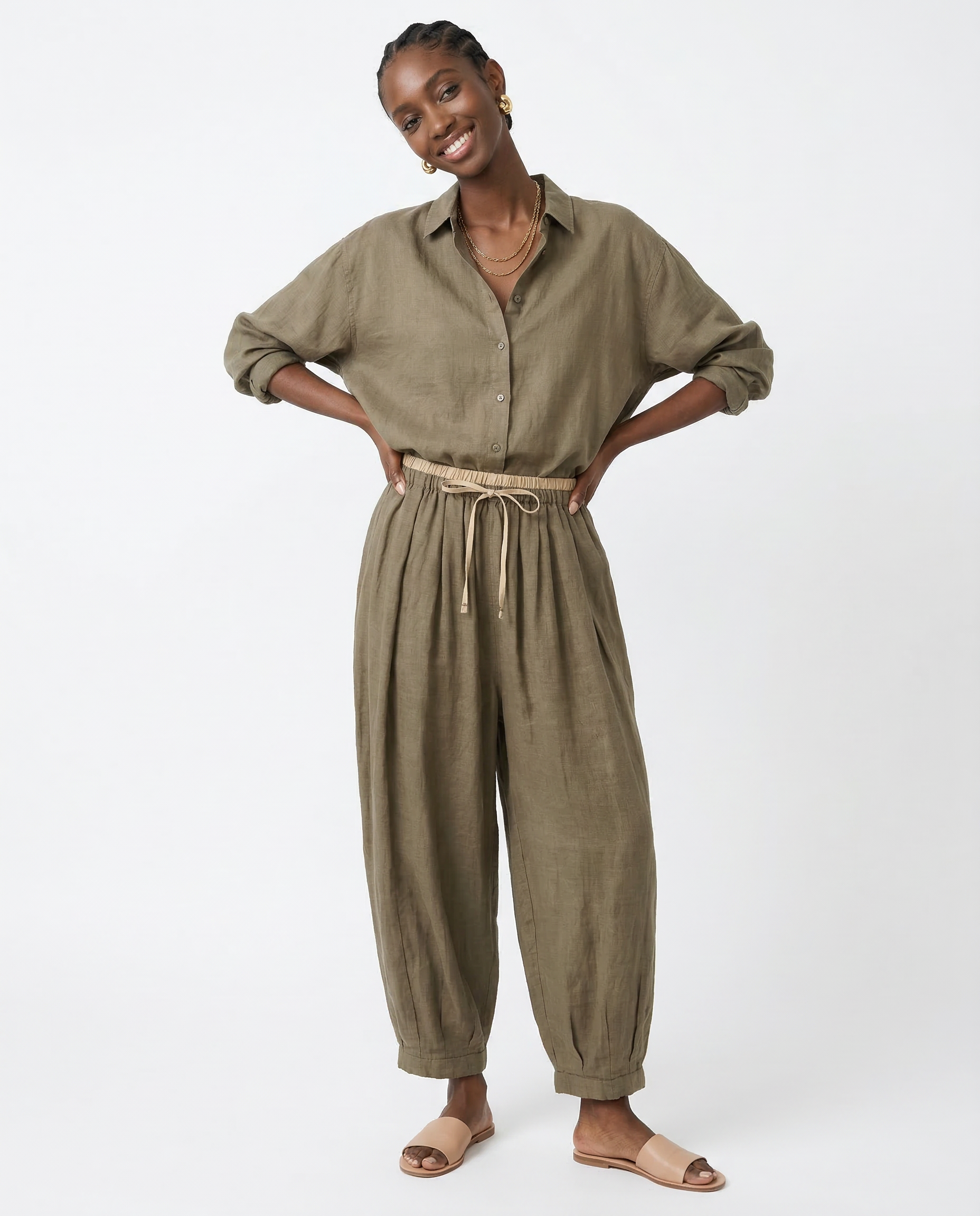 Loose tapered linen trousers for women by Christine Brewer, featuring a relaxed fit and pull-on style in natural linen fabric.