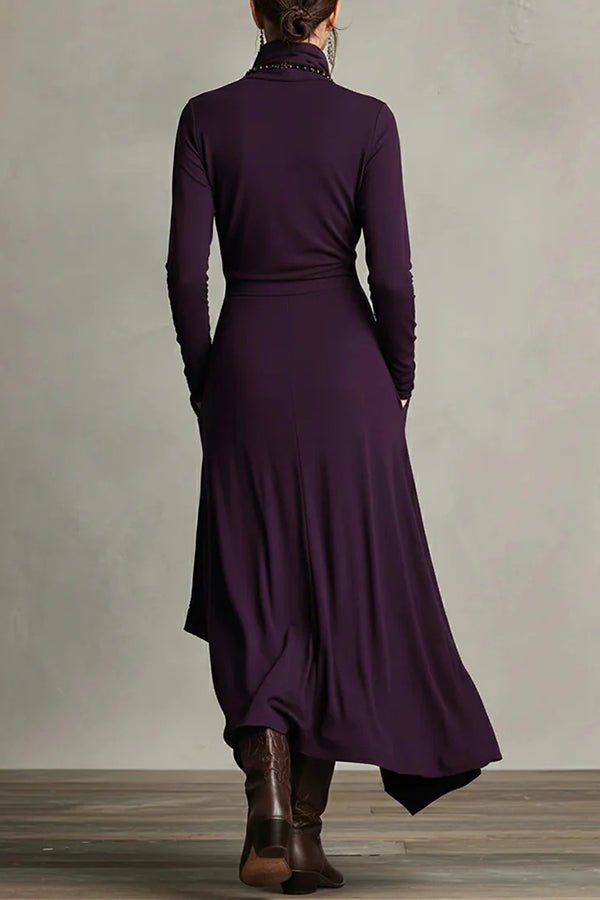Solid color high-neck long-sleeved irregular casual maxi dress by Christine Brewer, shown hanging with flowing fabric details.