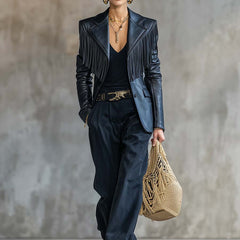 Black faux leather blazer with tassel details and notch lapel, stylish jacket by Christine Brewer, displayed on a hanger.