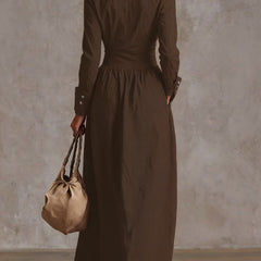 Christine Brewer high-waisted maxi dress with long sleeves, buttoned front, pleated pockets, and split-joint lapel in solid color.