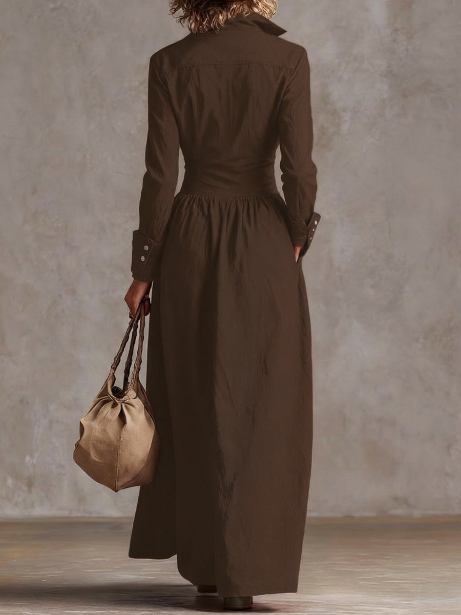 Christine Brewer high-waisted maxi dress with long sleeves, buttoned front, pleated pockets, and split-joint lapel in solid color.