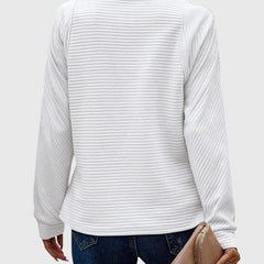Women’s Ruth half-zip sweater by Christine Brewer, featuring a cozy knit design in neutral tones.