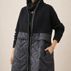 Long quilted puffer jacket for women by Christine Brewer, featuring a stylish design with a high collar and quilted pattern.