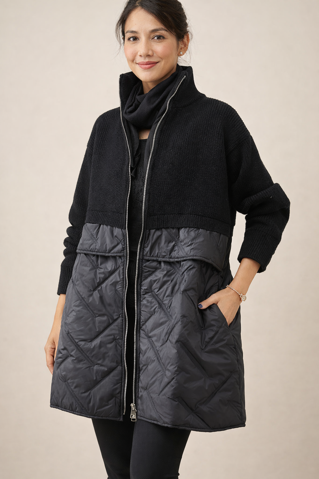 Long quilted puffer jacket for women by Christine Brewer, featuring a stylish design with a high collar and quilted pattern.