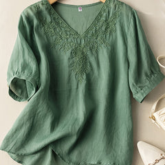 Light blue women's summer blouse by Christine Brewer featuring a V-neck and flowy linen fabric, casual and breathable top for warm weather.