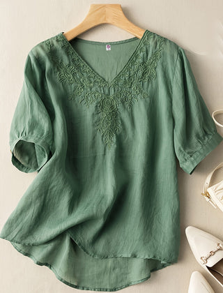 Light blue women's summer blouse by Christine Brewer featuring a V-neck and flowy linen fabric, casual and breathable top for warm weather.