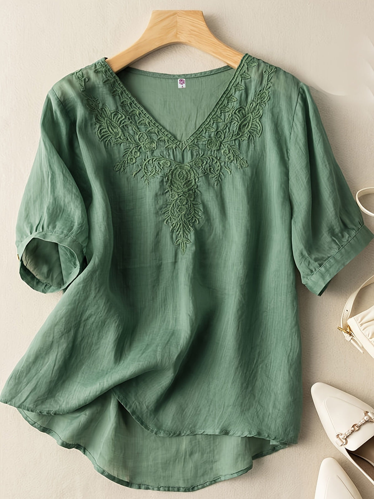 Light blue women's summer blouse by Christine Brewer featuring a V-neck and flowy linen fabric, casual and breathable top for warm weather.