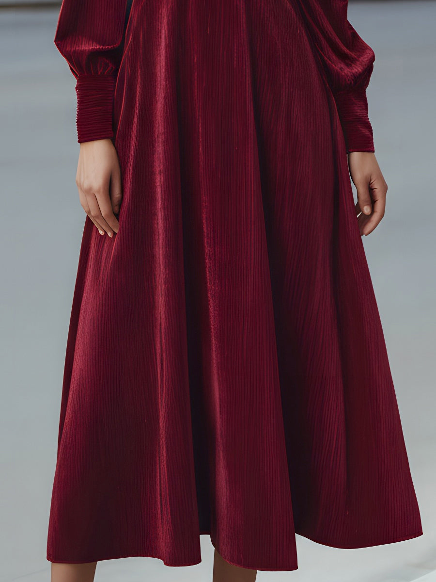 Burgundy velvet pleated bow-neck midi cocktail dress by Christine Brewer, featuring a fitted waist and elegant pleats.