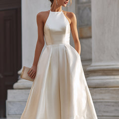 Christine Brewer halter-neck pleated midi dress for women, flowing fabric with a stylish midi-length design and elegant pleats.