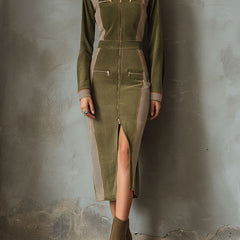 Olive green sleeveless midi dress with contrast panel and zip-up front by Christine Brewer, shown hanging on a clothing rack.