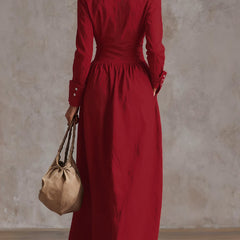 Christine Brewer high-waisted maxi dress with long sleeves, button details, pleated pockets, and a split-joint lapel in solid color.
