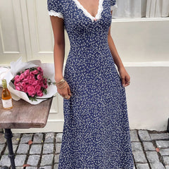 White floral lace patch V-neck maxi dress by Christine Brewer featuring delicate lace details and flowing fabric.