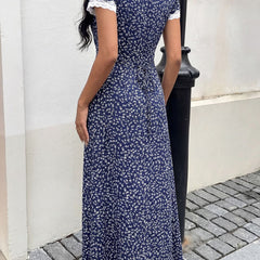 White lace patch floral V-neck maxi dress by Christine Brewer featuring intricate lace details and a flowing silhouette.