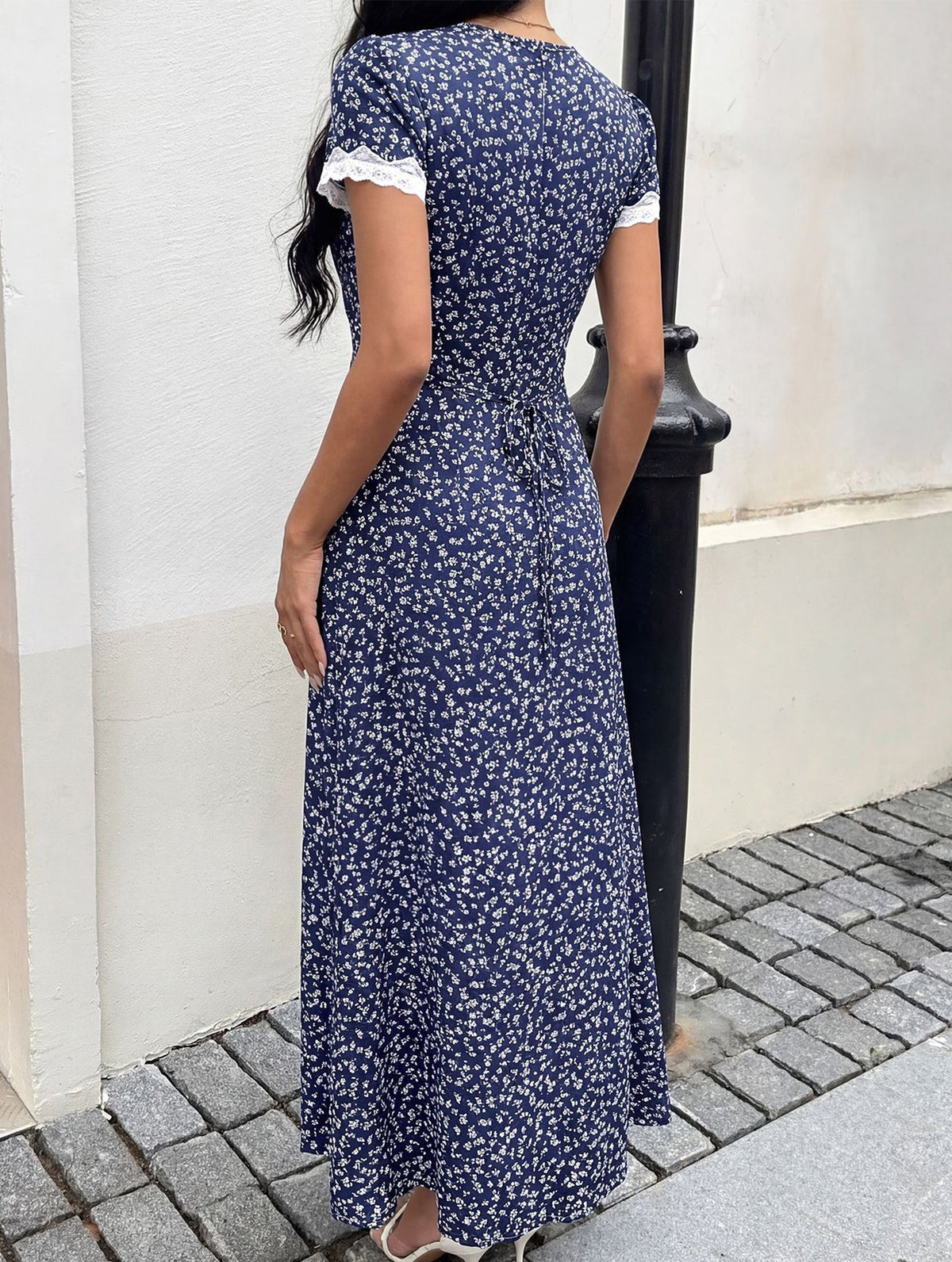 White lace patch floral V-neck maxi dress by Christine Brewer featuring intricate lace details and a flowing silhouette.