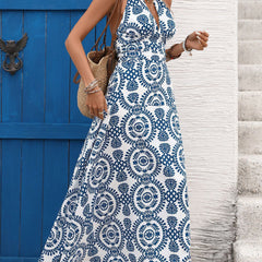 White halter print backless maxi dress by Christine Brewer, flowing sleeveless design with a stylish open back.