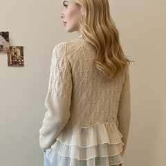 Back view of Christine Brewer women's rose-colored cable knit sweater, showcasing the textured knit fabric and relaxed fit.