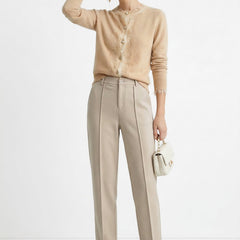 Women’s wool tapered trousers by Christine Brewer, featuring a comfortable fit and classic style in a neutral tone.