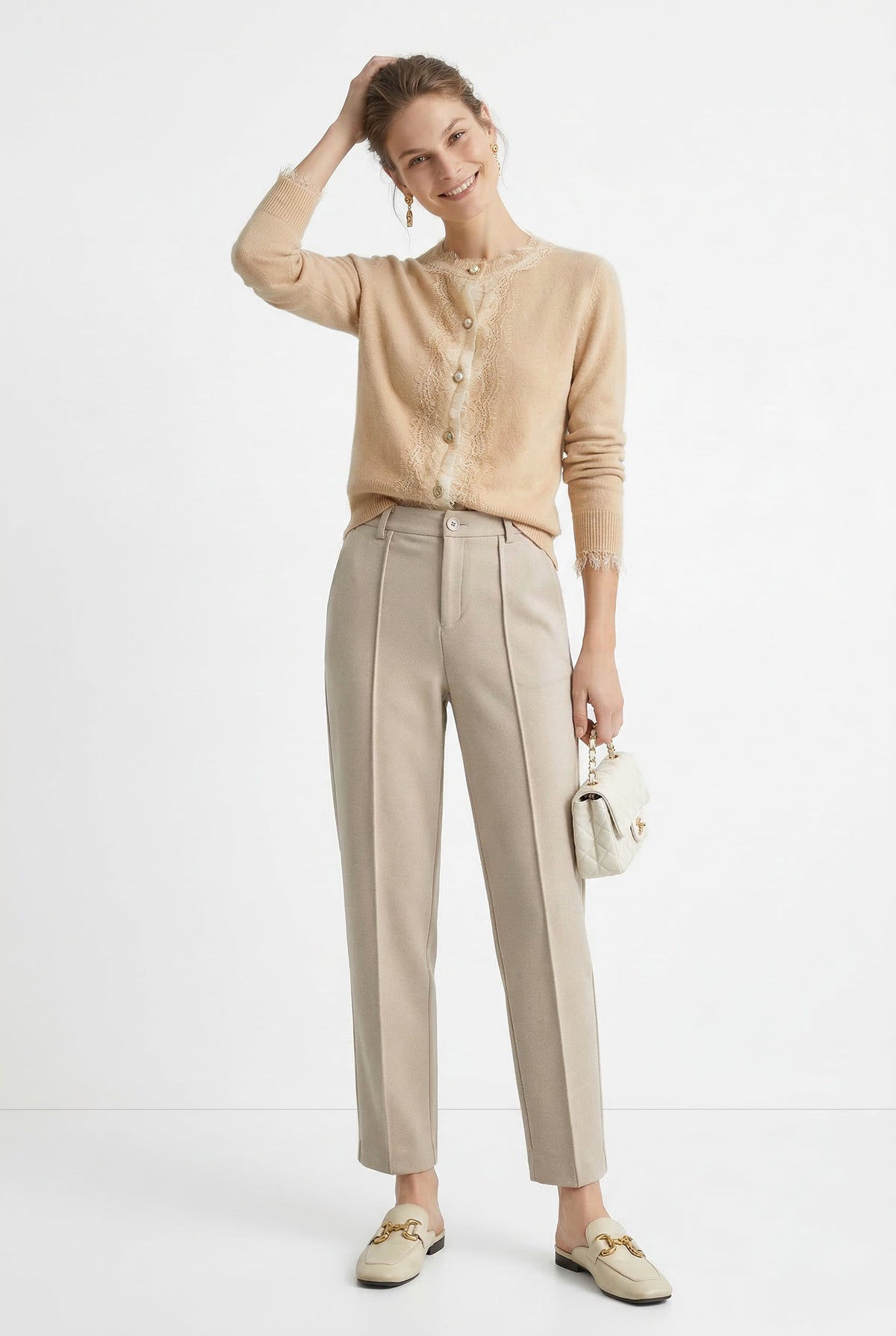 Women’s wool tapered trousers by Christine Brewer, featuring a comfortable fit and classic style in a neutral tone.