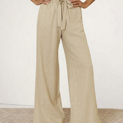 Women’s linen wide-leg trousers by Christine Brewer, showing loose pull-on design and soft fabric texture.