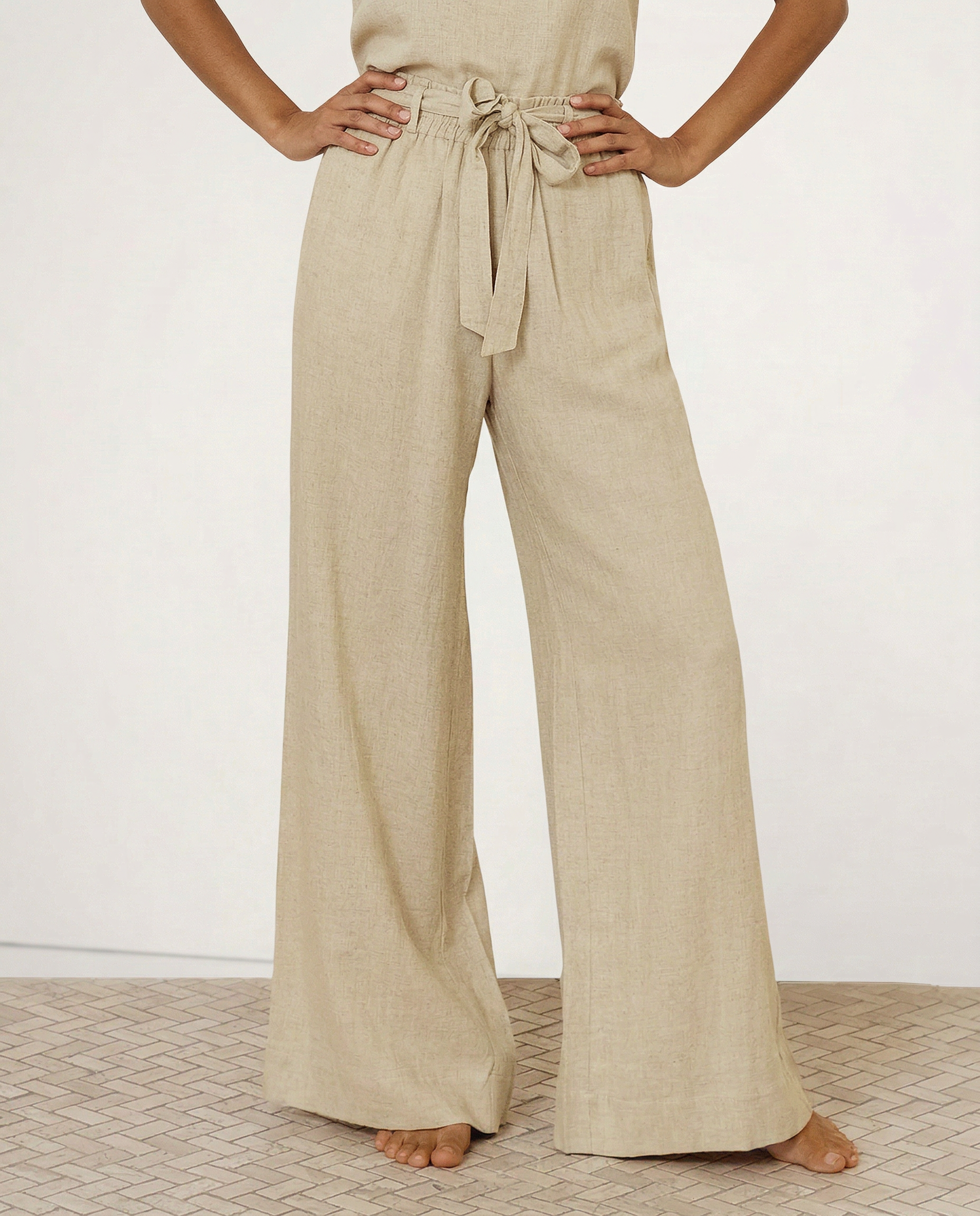 Women’s linen wide-leg trousers by Christine Brewer, showing loose pull-on design and soft fabric texture.