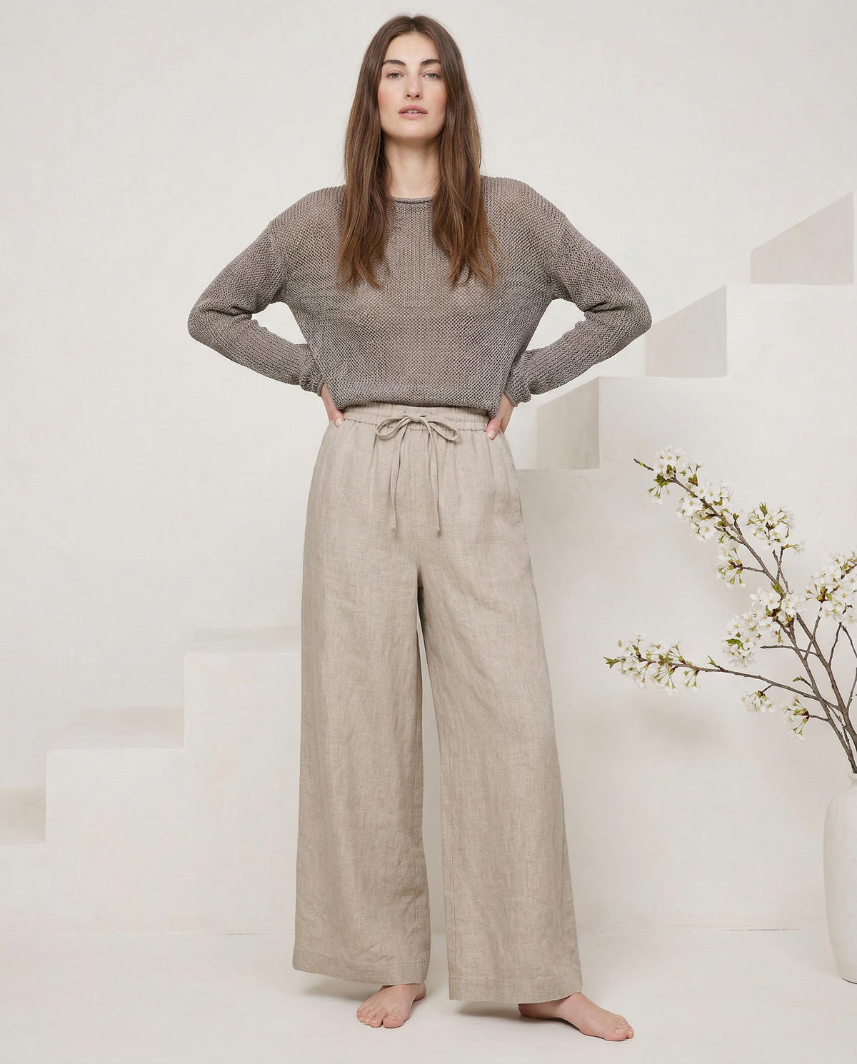 Light beige linen wide-leg trousers for women, loose pull-on style, showcasing soft fabric and relaxed fit.