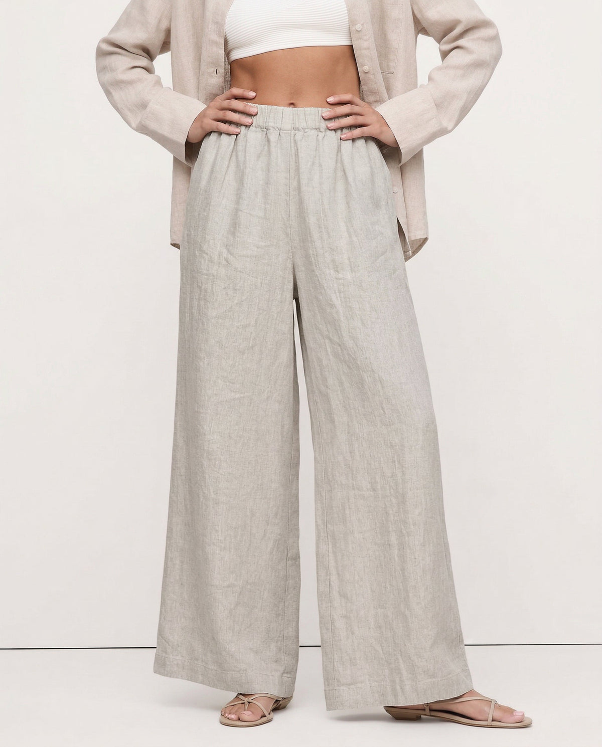 Linen cropped wide-leg drawstring trousers for women by Christine Brewer, shown in a realistic, high-quality fabric close-up.