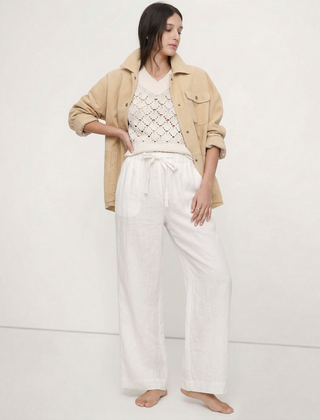 Light beige linen wide-leg women's trousers by Christine Brewer, showcasing soft fabric and relaxed pull-on style.