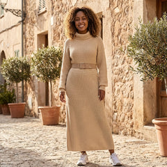 Ribbed knit midi dress with long sleeves and high neck by Christine Brewer, shown on a model in a neutral setting.