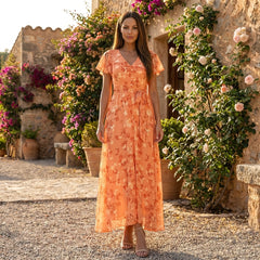Floral chiffon midi dress with short sleeves and flowing skirt by Christine Brewer, shown on a hanger with a soft background.