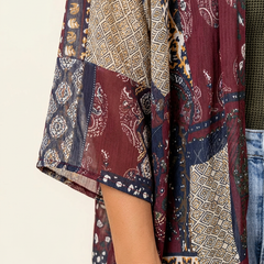 Plus size women’s open front kimono cardigan by Christine Brewer with semi-sheer fabric and side slits, styled as a versatile top.