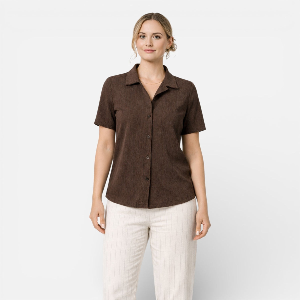 Women's short sleeve button-up shirt by Christine Brewer, classic fit, featuring a collar and front buttons, in a versatile style.