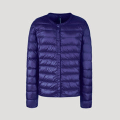 Lightweight blue quilted puffer jacket for women by Christine Brewer, featuring a cozy, stylish design with a high collar and quilted pattern.