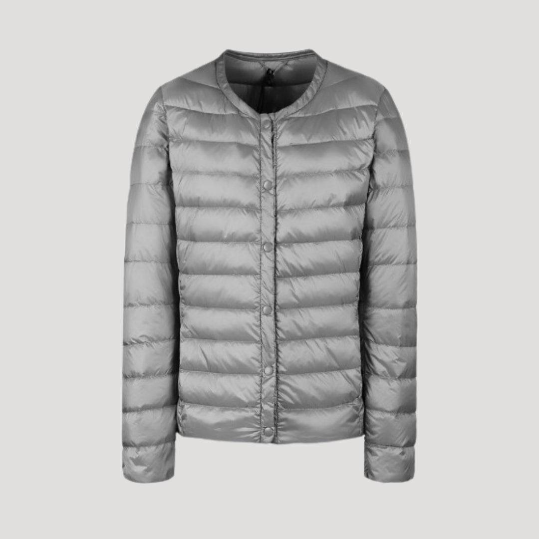 Light gray Lily quilted puffer jacket for women by Christine Brewer, shown with a lightweight, padded design and cozy fit.