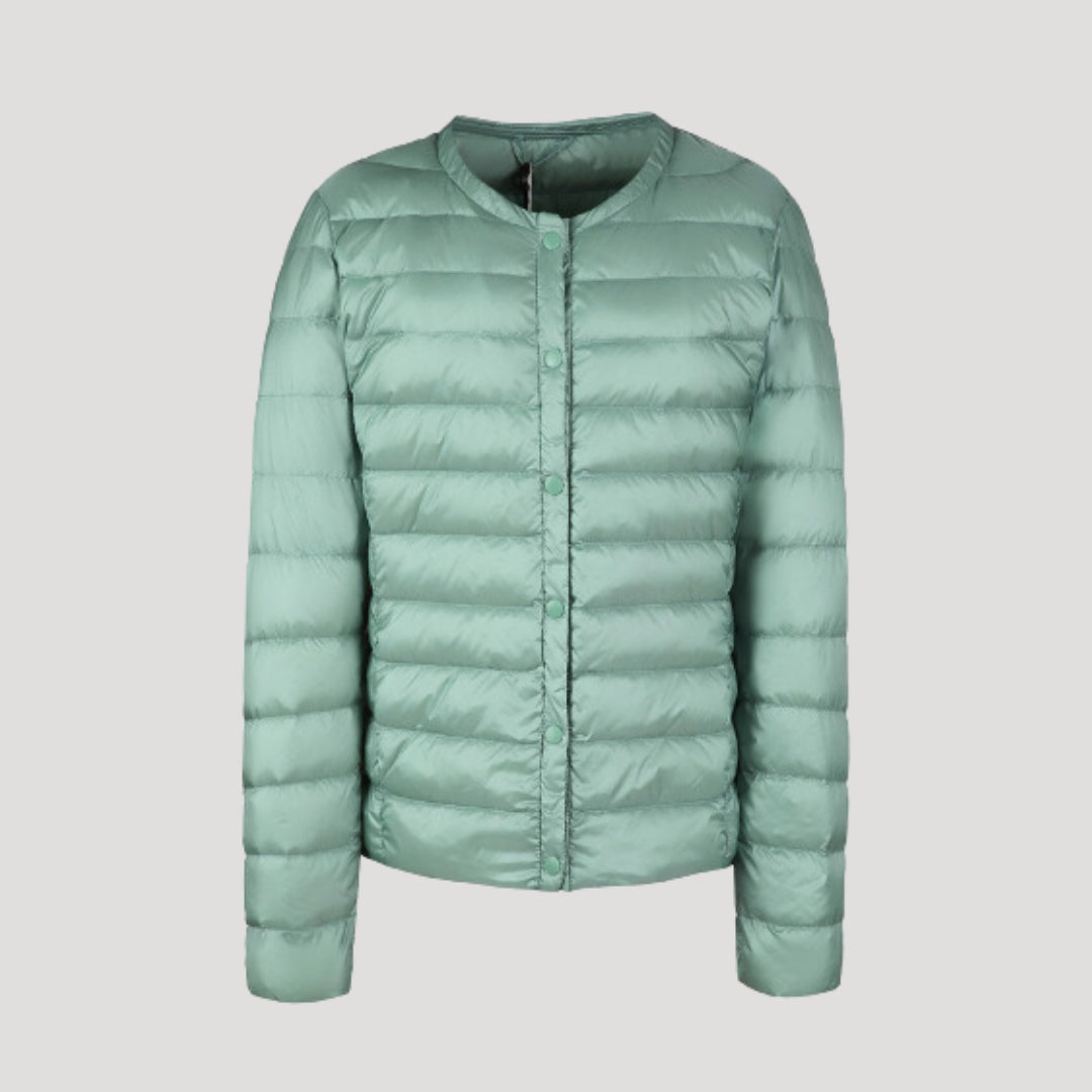 Lightweight green quilted puffer jacket for women by Christine Brewer, featuring a stylish, insulated design suitable for cold weather.