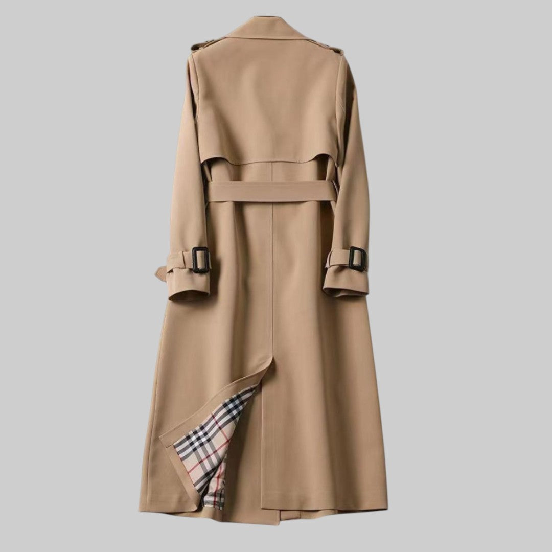 Women’s belted double-breasted long trench coat by Christine Brewer, shown in Jakarta style with classic design and belt detail.