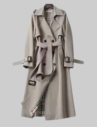 Women’s belted double-breasted long trench coat by Christine Brewer, shown in Jakarta with classic tailored design.