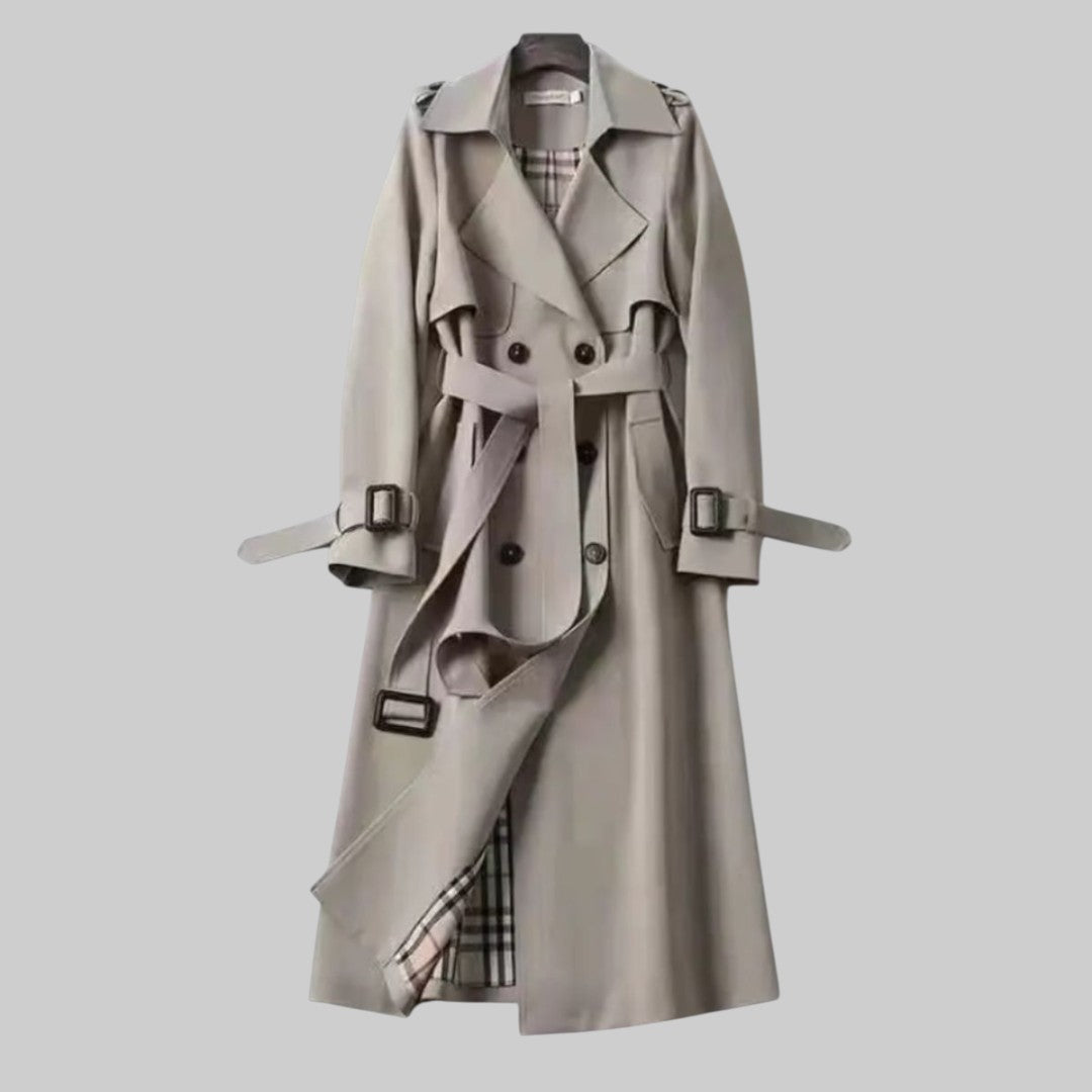 Women’s belted double-breasted long trench coat by Christine Brewer, shown in Jakarta with classic tailored design.