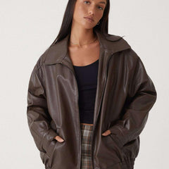 Josephine oversized faux leather bomber jacket for women by Christine Brewer in brown, displayed on a hanger.