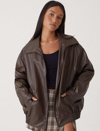 Josephine oversized faux leather bomber jacket for women by Christine Brewer in brown, displayed on a hanger.