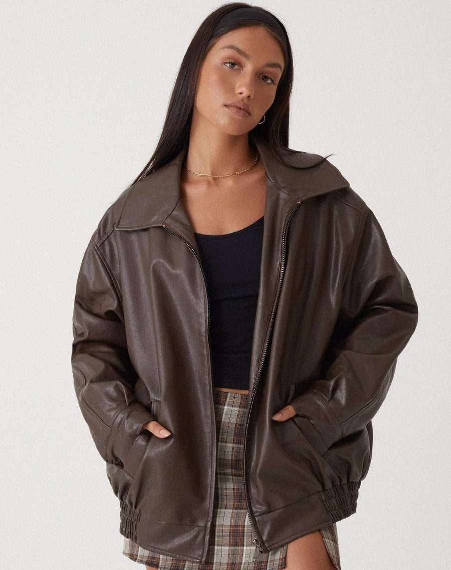 Josephine oversized faux leather bomber jacket for women by Christine Brewer in brown, displayed on a hanger.