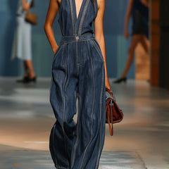 Dark blue denim sleeveless jumpsuit with V-neck and wide-leg pants, designed for women by Christine Brewer.