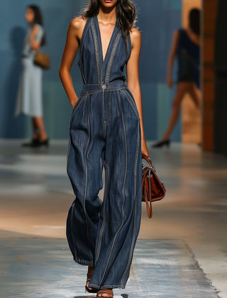 Dark blue denim sleeveless jumpsuit with V-neck and wide-leg pants, designed for women by Christine Brewer.